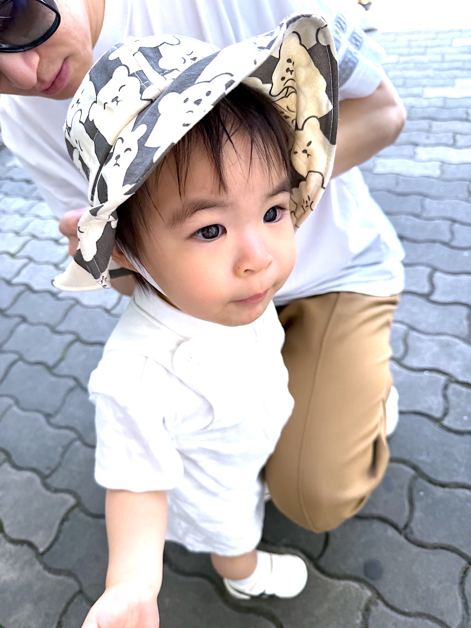 Trying on her new animal-themed hat — ready for more adventures under the sun!